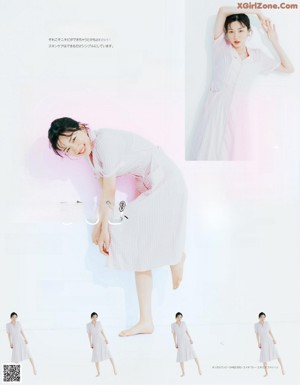 A woman laying on top of a bed next to a pink heart.