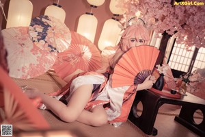 A woman in a kimono is sitting on the floor.