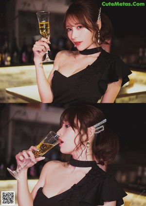 A woman in a black dress holding a glass of wine.
