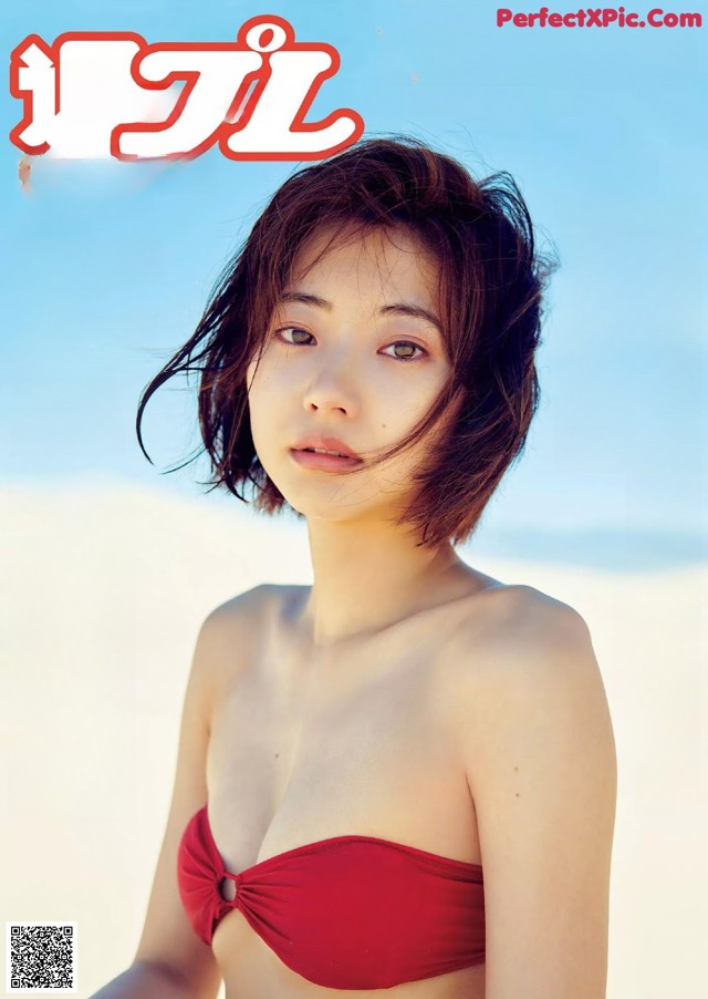 A woman in a red bikini on the cover of a magazine.