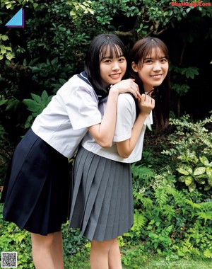 A couple of young women standing next to each other.