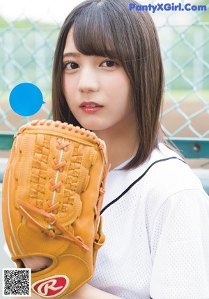 A woman in a school uniform holding a black bag.