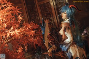 A woman with blue hair sitting on a rug in a room.