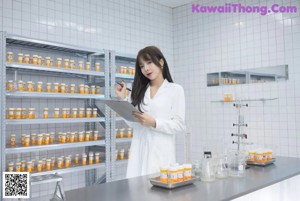 A woman sitting on a stool in a pharmacy.