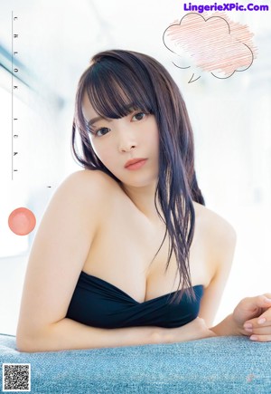 A woman in a blue bathing suit posing for a magazine cover.